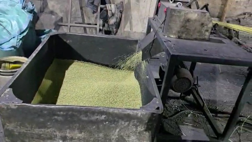 Crusher hopper with yellow-green plastic flakes